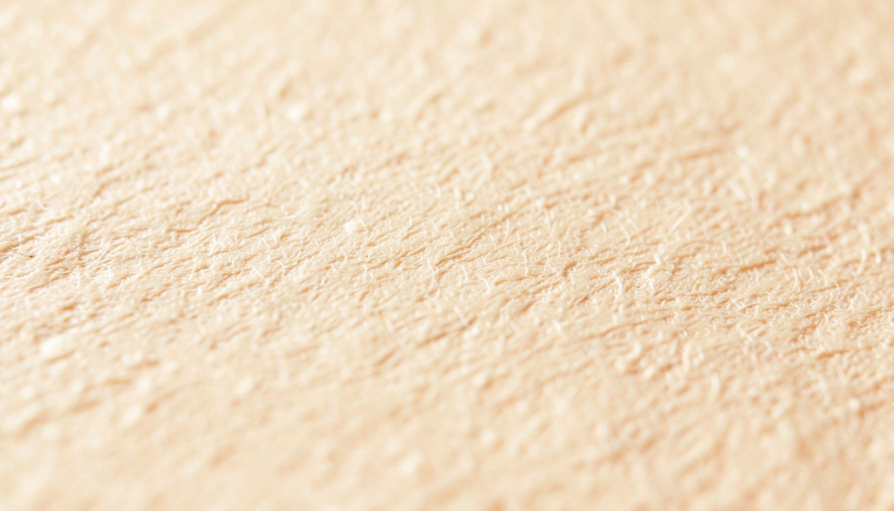 Warm cream-colored textured paper surface with subtle fibrous grain and soft beige tones